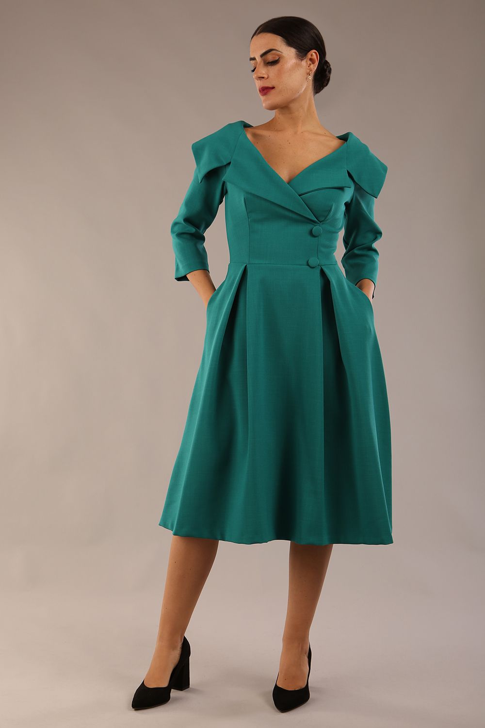 model is wearing diva catwalk gatsby swing dress with pocket detail and wide v-neck collar and buttons down the front panel in parasailing green front