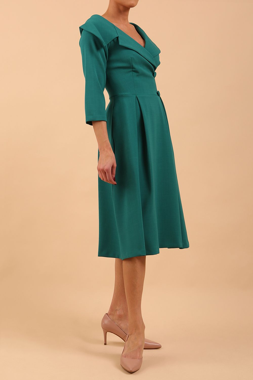model is wearing diva catwalk gatsby swing dress with pocket detail and wide v-neck collar and buttons down the front panel in parasailing green front