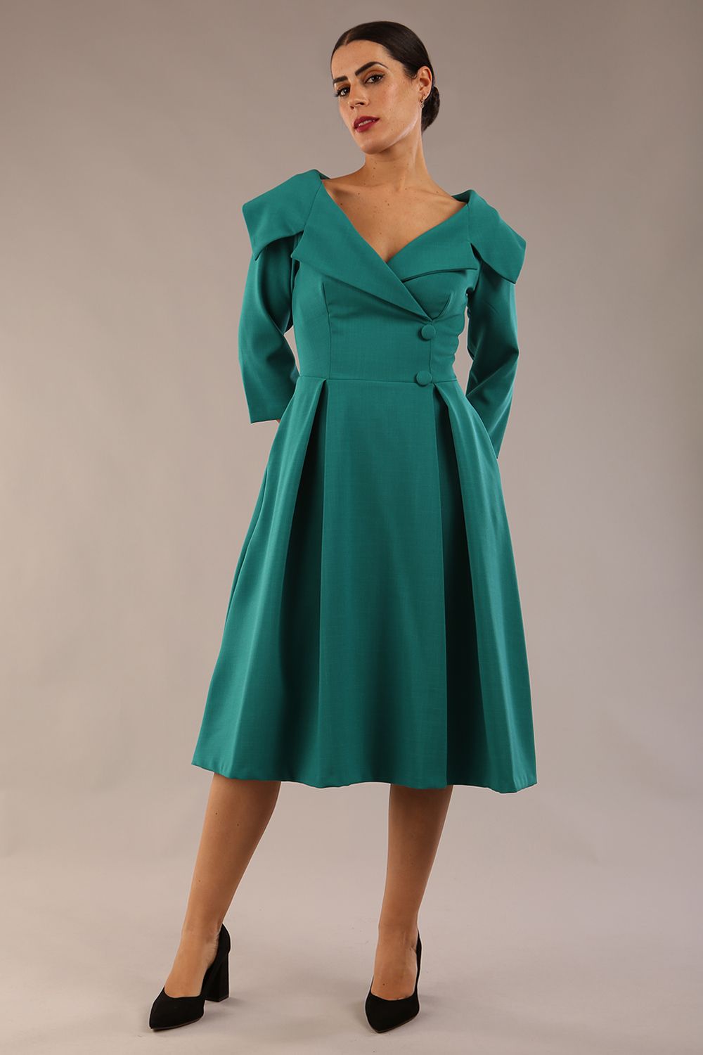 model is wearing diva catwalk gatsby swing dress with pocket detail and wide v-neck collar and buttons down the front panel in parasailing green front