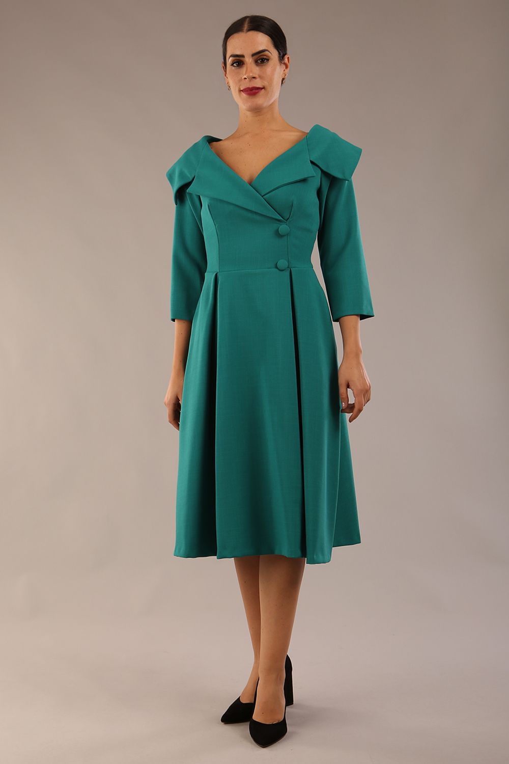 model is wearing diva catwalk gatsby swing dress with pocket detail and wide v-neck collar and buttons down the front panel in parasailing green front