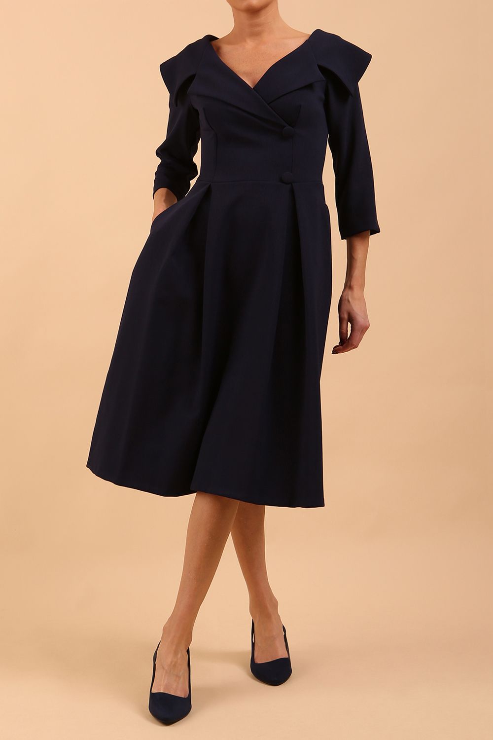 model is wearing a sleeved oversized collar swing dress with button detail at the front and pockets in the skirtmodel is wearing diva catwalk gatsby swing dress with pocket detail and wide v-neck collar and buttons down the front panel in navy blue front