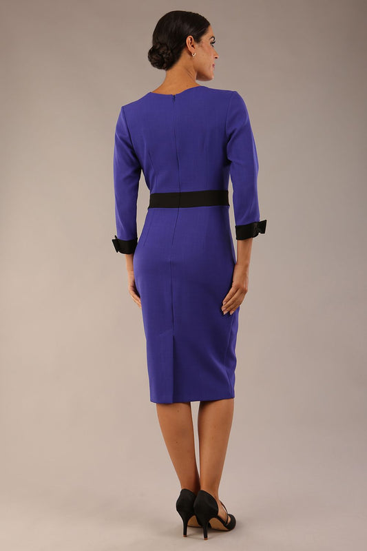 Model wearing diva catwalk Reese 3/4 Sleeved pencil skirt dress with a contrast sleeve and waistband details in Indigo Blue/Black