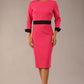 Model wearing diva catwalk Reese 3/4 Sleeved pencil skirt dress with a contrast sleeve and waistband details in Fuschia Pink/Black