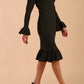Model wearing Macarena Peplum Hem Bodycon Pencil Dress with Long sleeves with peplum details at the ends and High neckline with overlapping keyhole detail in Obsidian Green colour front side