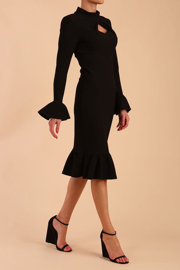 Model wearing Macarena Peplum Hem Bodycon Pencil Dress with Long sleeves with peplum details at the ends and High neckline with overlapping keyhole detail in Black colour front side