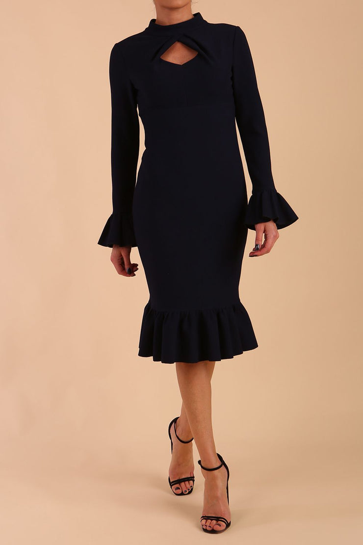 Model wearing Macarena Peplum Hem Bodycon Pencil Dress with Long sleeves with peplum details at the ends and High neckline with overlapping keyhole detail in Dark Navy colour front 