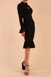 Model wearing Macarena Peplum Hem Bodycon Pencil Dress with Long sleeves with peplum details at the ends and High neckline with overlapping keyhole detail in Black colour front side