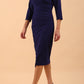  model is wearing diva catwalk liesel wrap pencil sleeved dress with collar half way around low v-neck in oxford blue front