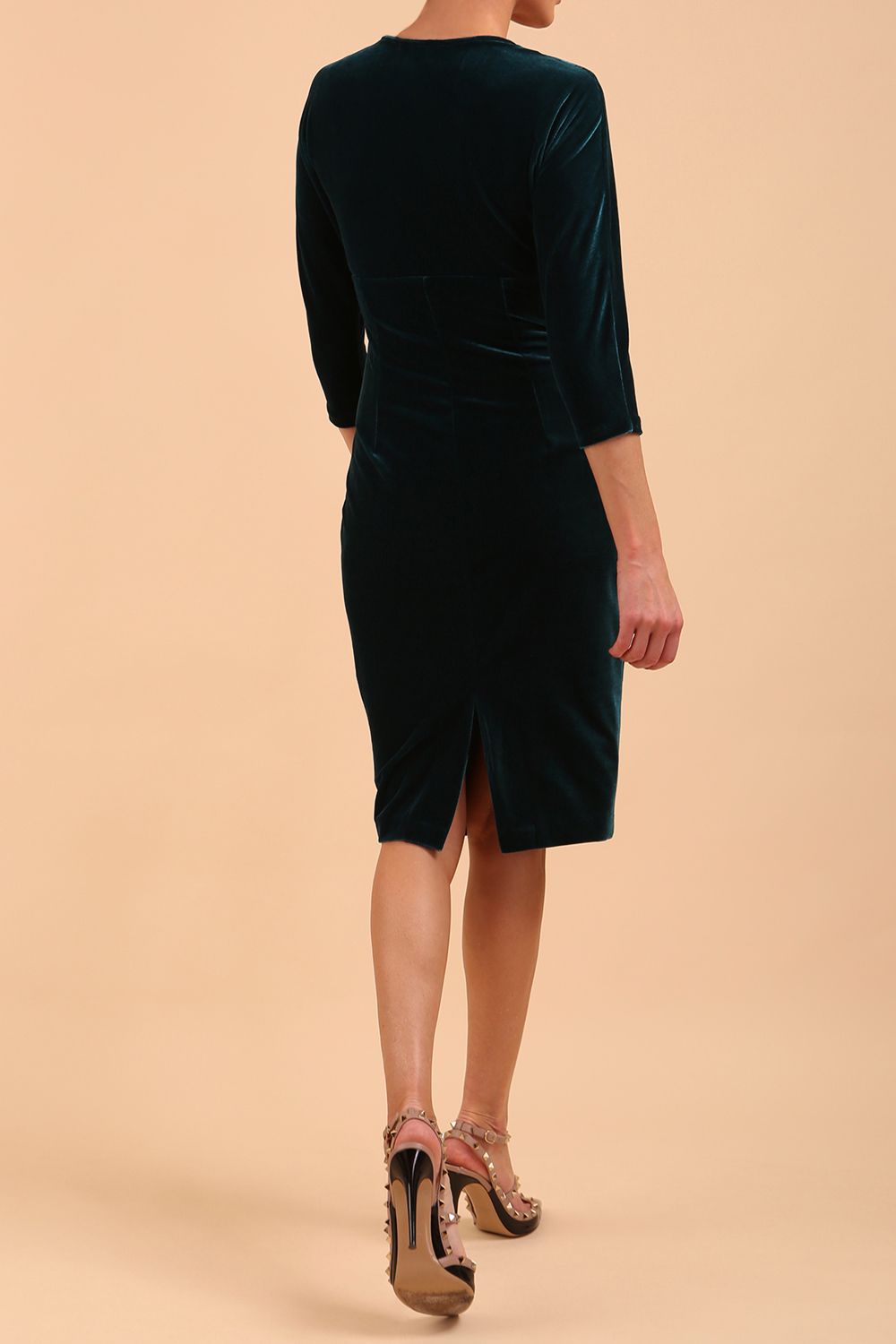 A model is wearing a velvet pencil sweetheart neckline dress by diva catwalk in teal