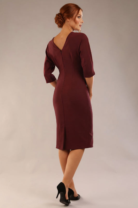Model wearing the SEED Fulham pencil dress in port royale, showing the clean boat neckline and dolman sleeves (Port Royale)