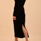 A Model is wearing an off shoulder bardot neckline velvet stretch midi dress in black by diva catwalk back