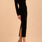 A Model is wearing an off shoulder bardot neckline velvet stretch midi dress in black by diva catwalk front side