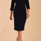 Model is wearing a 3/4 sleeve pencil dress with the keyhole details in navy