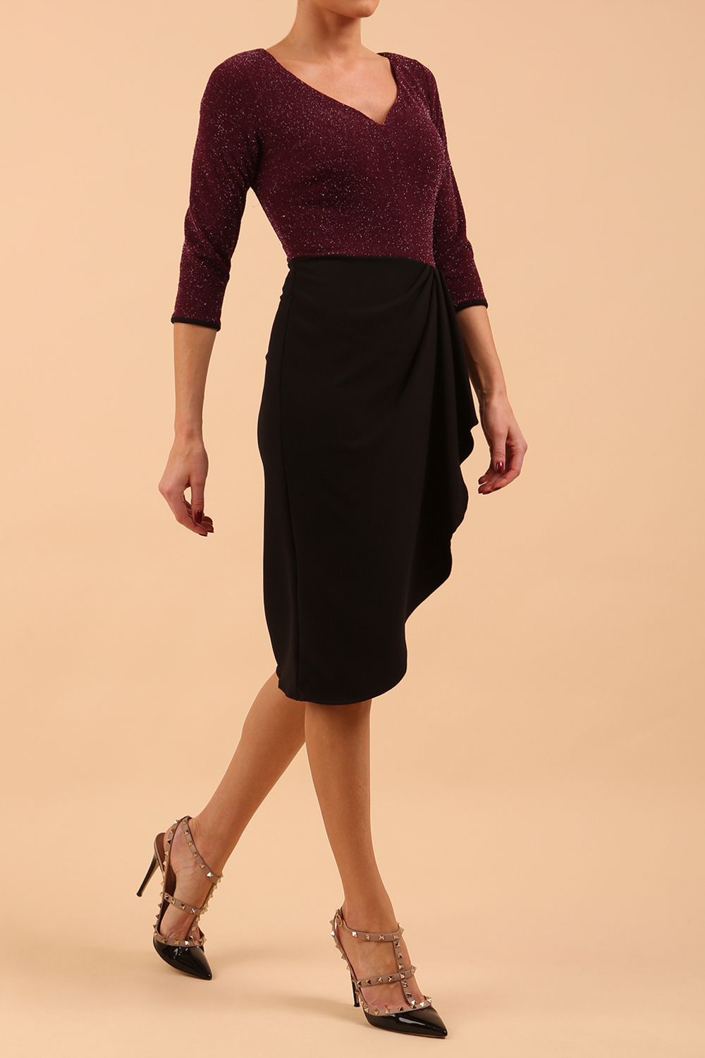 model is wearing diva catwalk contrast pencil dress with sleeve and asymmetric skirt detail in black and burgundy sparkle front