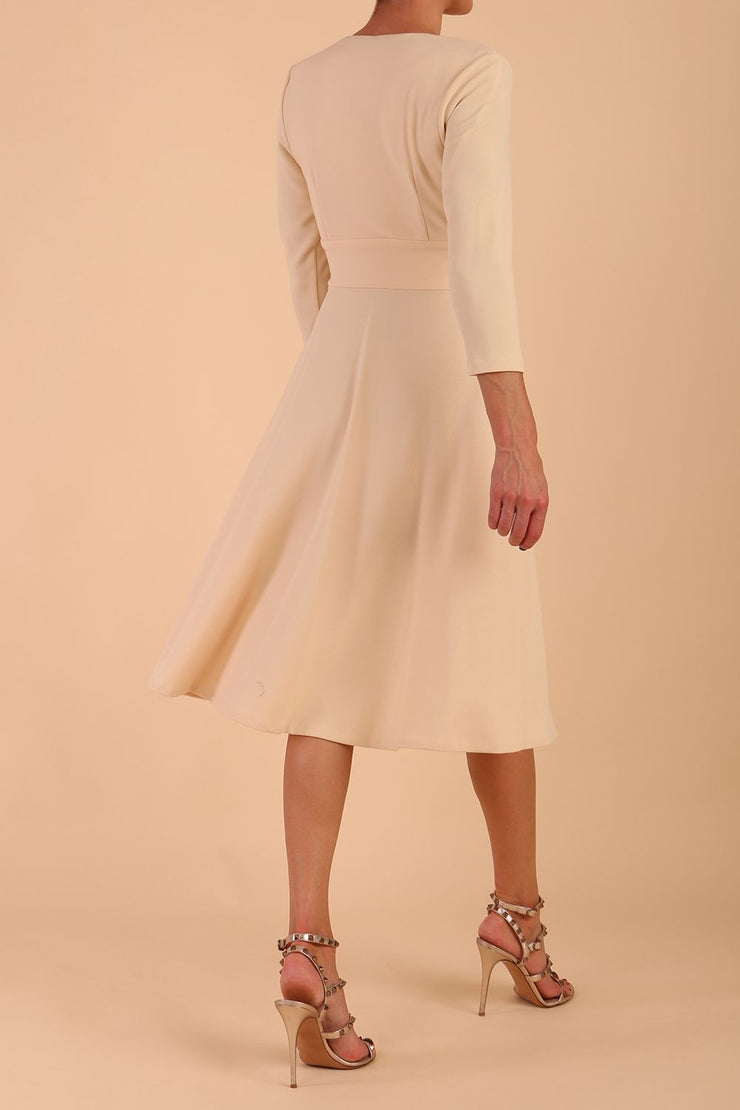 model is wearing diva catwalk january 3/4 sleeves a-line v-neck swing dress in beige back