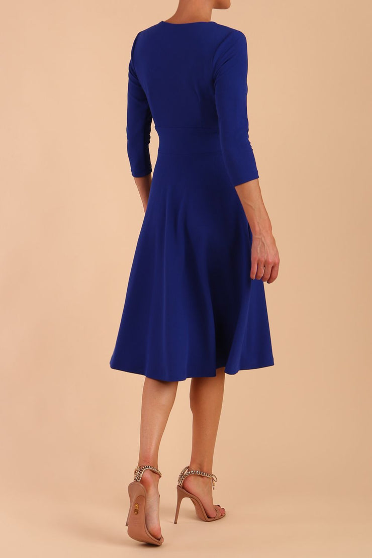  model is wearing diva catwalk january sleeved a-line v-neck dress in royal blue back