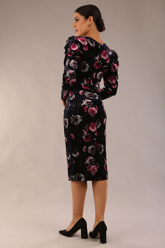 model is wearing a diva catwalk Gardenia Floral Velvet Ruched Front and Back Dress long puff sleeves with round neckline with V slit and front vent with draped lapel and midi length dress in floral velvet back