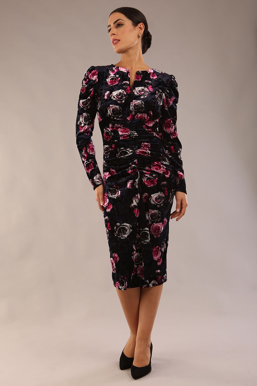 model is wearing a diva catwalk Gardenia Floral Velvet Ruched Front and Back Dress long puff sleeves with round neckline with V slit and front vent with draped lapel and midi length dress in floral velvet