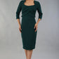 Model wearing Diva Catwalk Lantana Square Neck Pencil Dress 3/4 Sleeve in Forest Green front