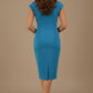 Woman wearing a blue dress with a belt on a beige background (Malibu Blue)