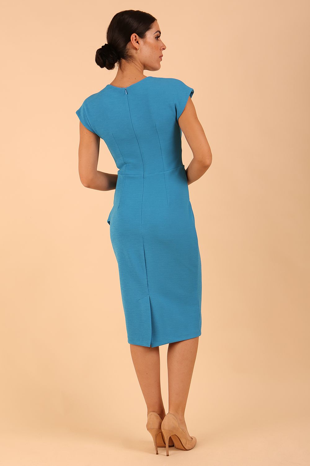 model is wearing diva catwalk Ester cap sleeve pencil dress with v-neck and bow detail at the front in malibu blue back