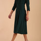 model is wearing diva catwalk harpsden a-line skirt 3/4 sleeve swing dress with rounded neckline in forest green side