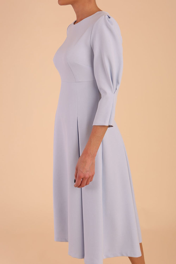 model is wearing diva catwalk harpsden a-line skirt 3/4 sleeve swing dress with rounded neckline in Celestial Blue front side detail sleeve