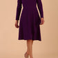 model is wearing diva catwalk moraig swing long sleeve dress with high cowl neckline and wrap skirt in deep purple front