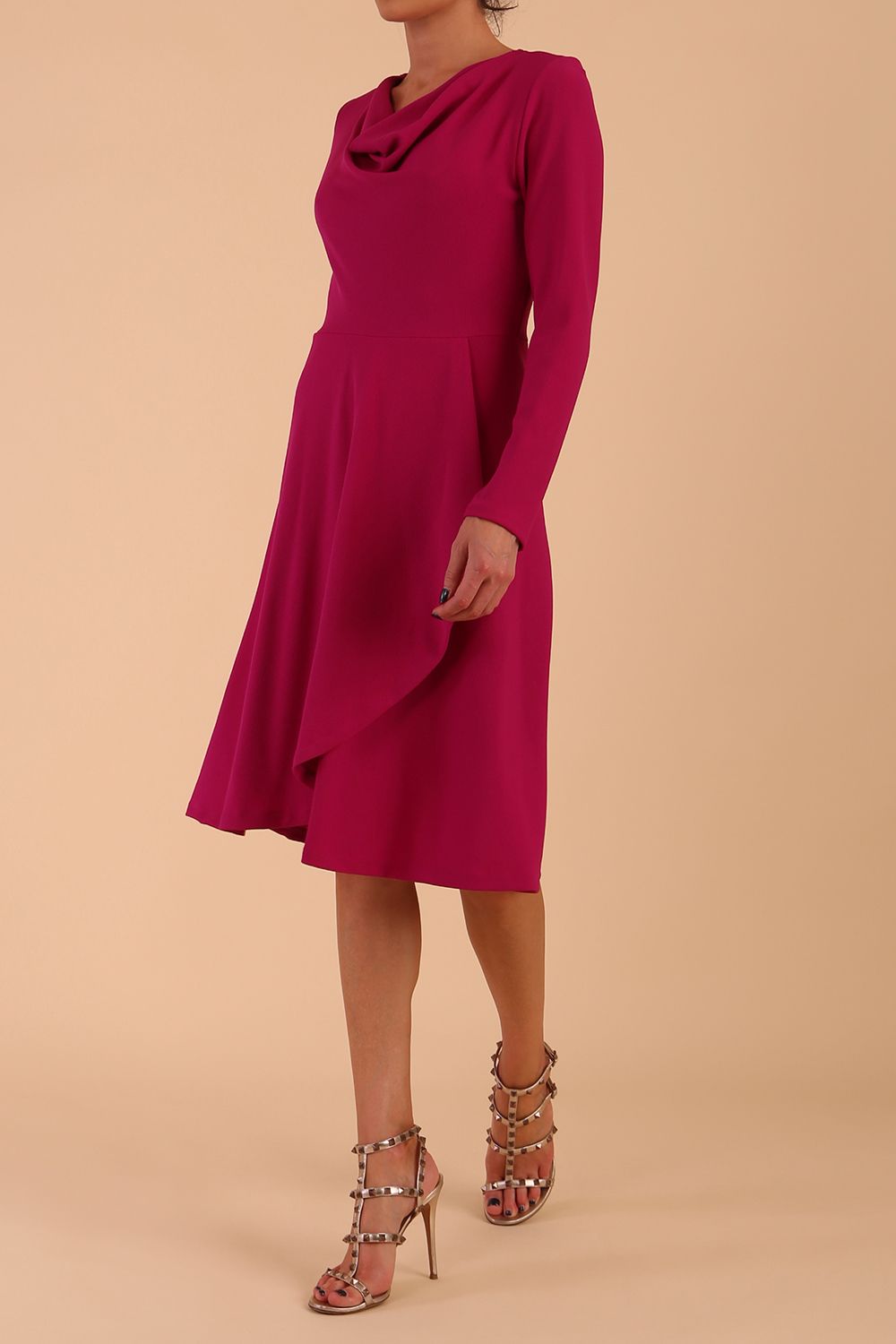 model is wearing diva catwalk moraig swing long sleeve dress with high cowl neckline and wrap skirt in magenta front