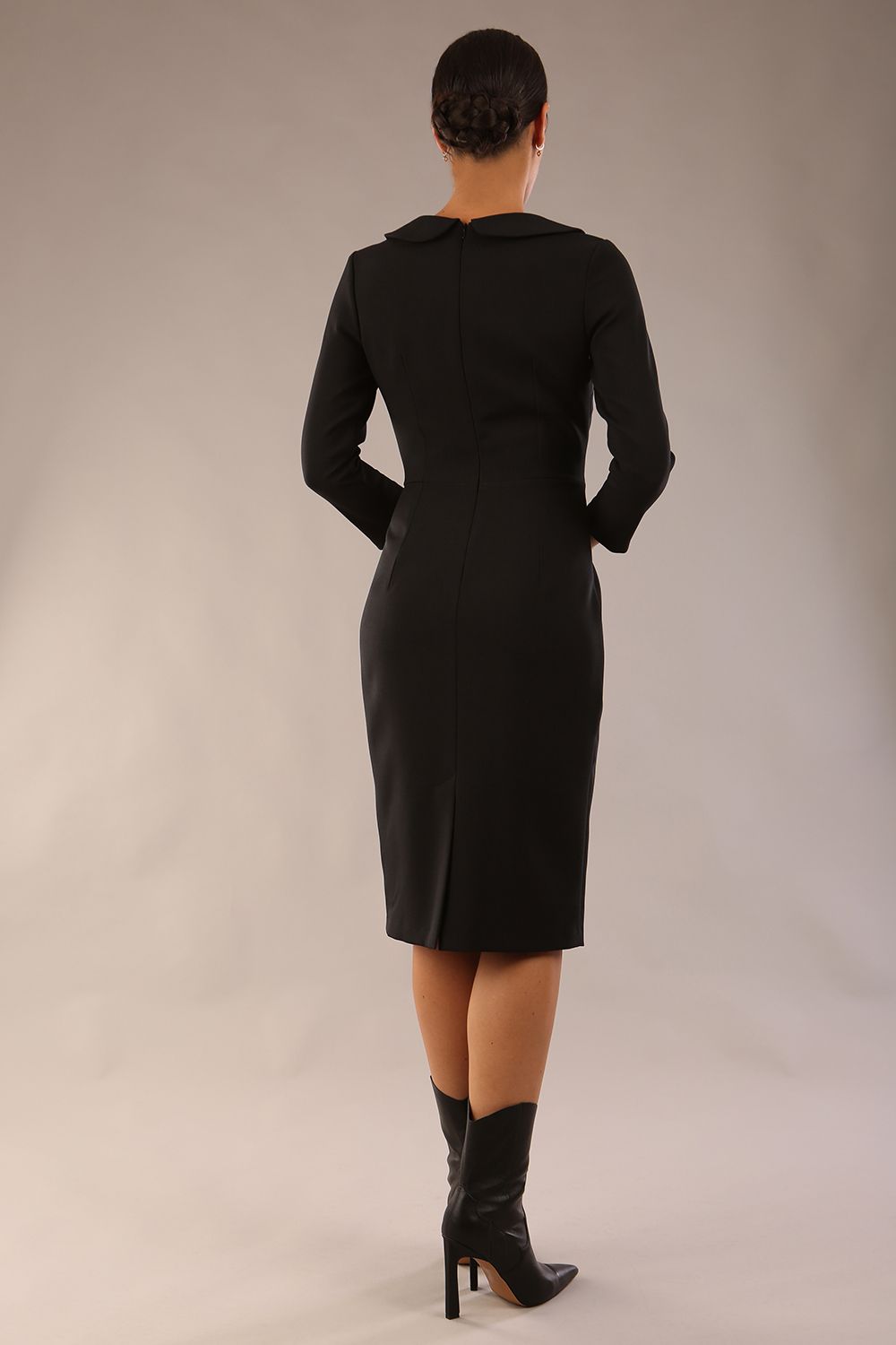 model wearing a diva catwalk  Helium 3/4 Sleeved Pencil Dress with 3/4 sleeve and knee length and bow detail on the neckline in black colour