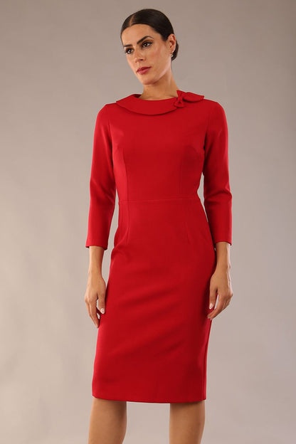 model wearing a diva catwalk  Helium 3/4 Sleeved Pencil Dress with 3/4 sleeve and knee length and bow detail on the neckline in dark red colour