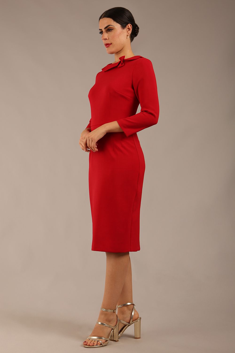 brunette model is wearing a diva catwalk  Helium 3/4 Sleeved Pencil Dress with 3/4 sleeve and knee length and bow detail on the neckline in dark red colour front 