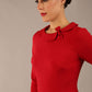 brunette model is wearing a diva catwalk  Helium 3/4 Sleeved Pencil Dress with 3/4 sleeve and knee length and bow detail on the neckline in dark red colour front close up