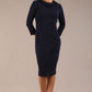 brunette model is wearing a diva catwalk  Helium 3/4 Sleeved Pencil Dress with 3/4 sleeve and knee length and bow detail on the neckline in navy blue colour front 