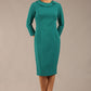 brunette model is wearing a diva catwalk  Helium 3/4 Sleeved Pencil Dress with 3/4 sleeve and knee length and bow detail on the neckline in parasailing green colour front 