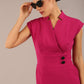brunette Model is wearing a diva catwalk Derby pencil skirt dress cap sleeves with buttons details at the waistband and star neckline below the knee length with pockets in magenta colour front image with sunglasses