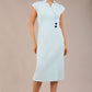 brunette Model is wearing a diva catwalk Derby pencil skirt dress cap sleeves with buttons details at the waistband and star neckline below the knee length with pockets in sky blue colour front image 