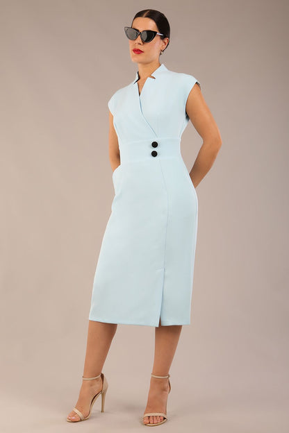 brunette Model is wearing a diva catwalk Derby pencil skirt dress cap sleeves with buttons details at the waistband and star neckline below the knee length with pockets in sky blue colour front image with sunglasses