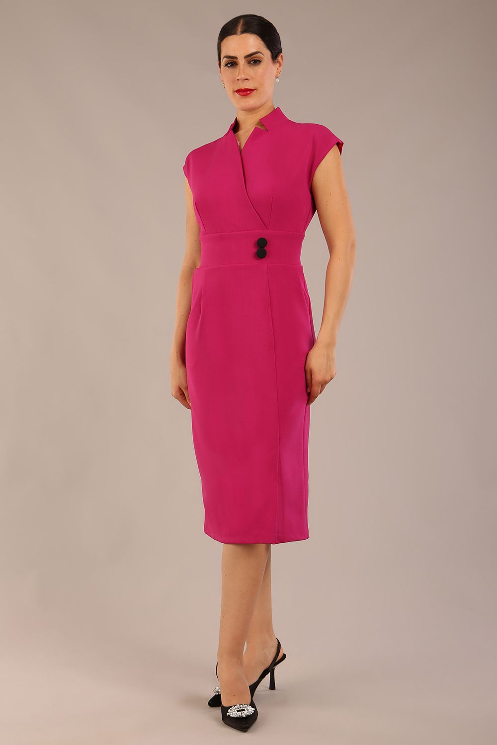 brunette Model is wearing a diva catwalk Derby pencil skirt dress cap sleeves with buttons details at the waistband and star neckline below the knee length with pockets in magenta colour front image 