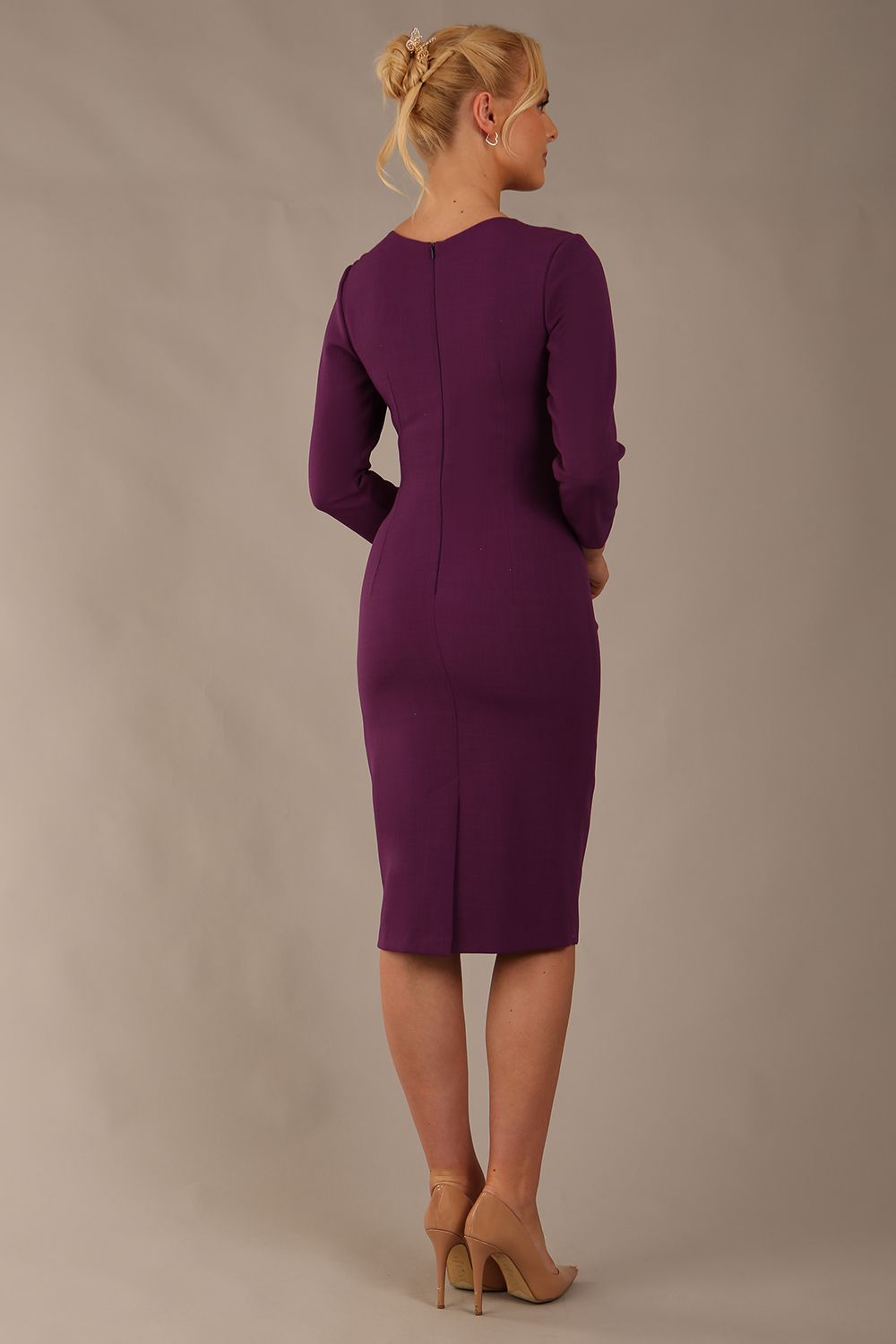 model is wearing diva catwalk miracle pencil dress with keyhole detail on a side of the front panel and gathering detail on a side or bodice panel with sleeves in Imperial Purple colour back (Imperial Purple)