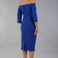 model is wearing diva catwalk lauren odd shoulder asymmetric neckline pencil dress with sleeves in cobalt blue back