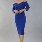 model is wearing diva catwalk lauren odd shoulder asymmetric neckline pencil dress with sleeves in cobalt blue front