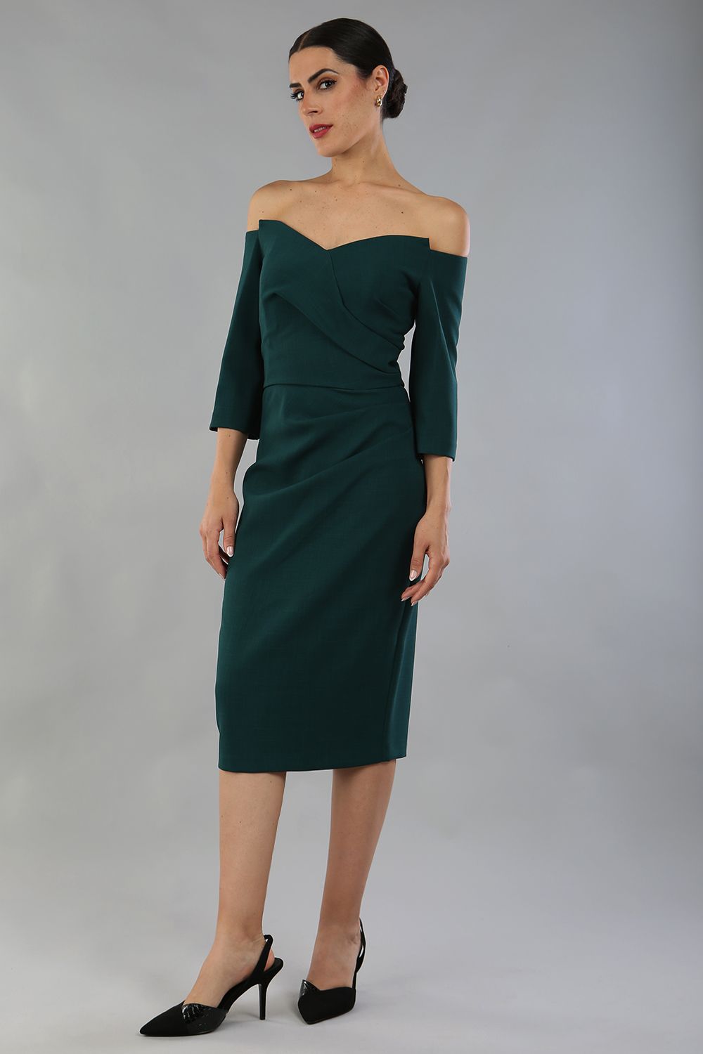 model is wearing diva catwalk lauren odd shoulder asymmetric neckline pencil dress with sleeves in forest green front