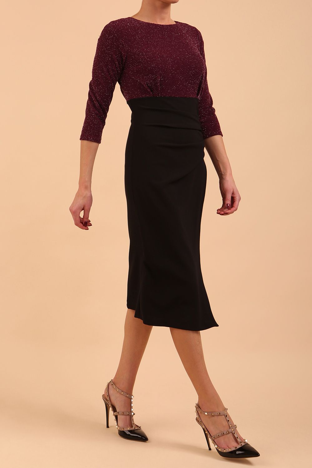 model is wearing diva catwalk contrast pencil dress with sleeve and assymetric skirt detail in black and burgundy sparkle front side