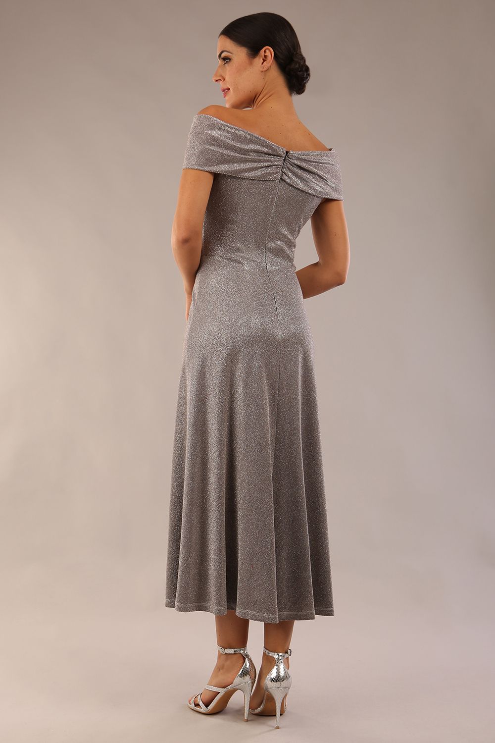 Model is wearing diva catwalk Capri A-Line Midaxi Glitter Dress off the shoulders in Iris Silver Glitter back