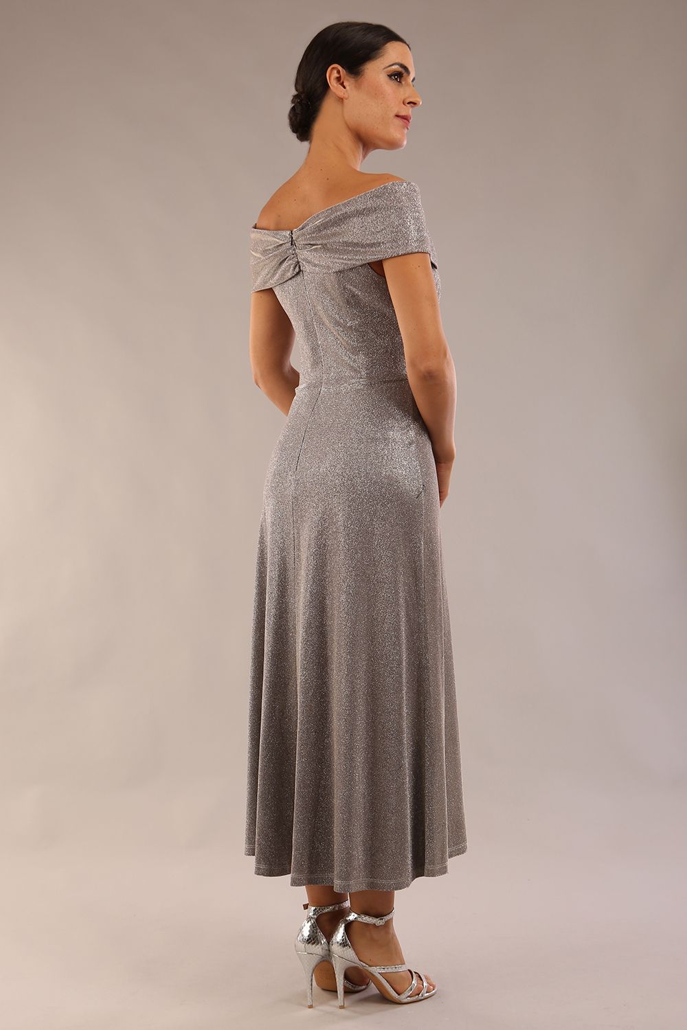 Model is wearing diva catwalk Capri A-Line Midaxi Glitter Dress off the shoulders in Iris Silver Glitter back