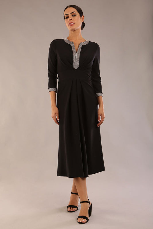 model is wearing diva catwalk carolyn swing midi dress with a band and iris silver glitter detail on sleeves and around the neckline in black colour back