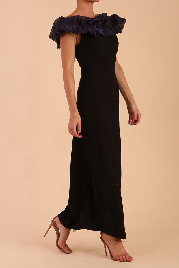 brunette model is wearing diva catwalk classique maxi black dress with off shoulder organza detail without sleeves in black and navy side