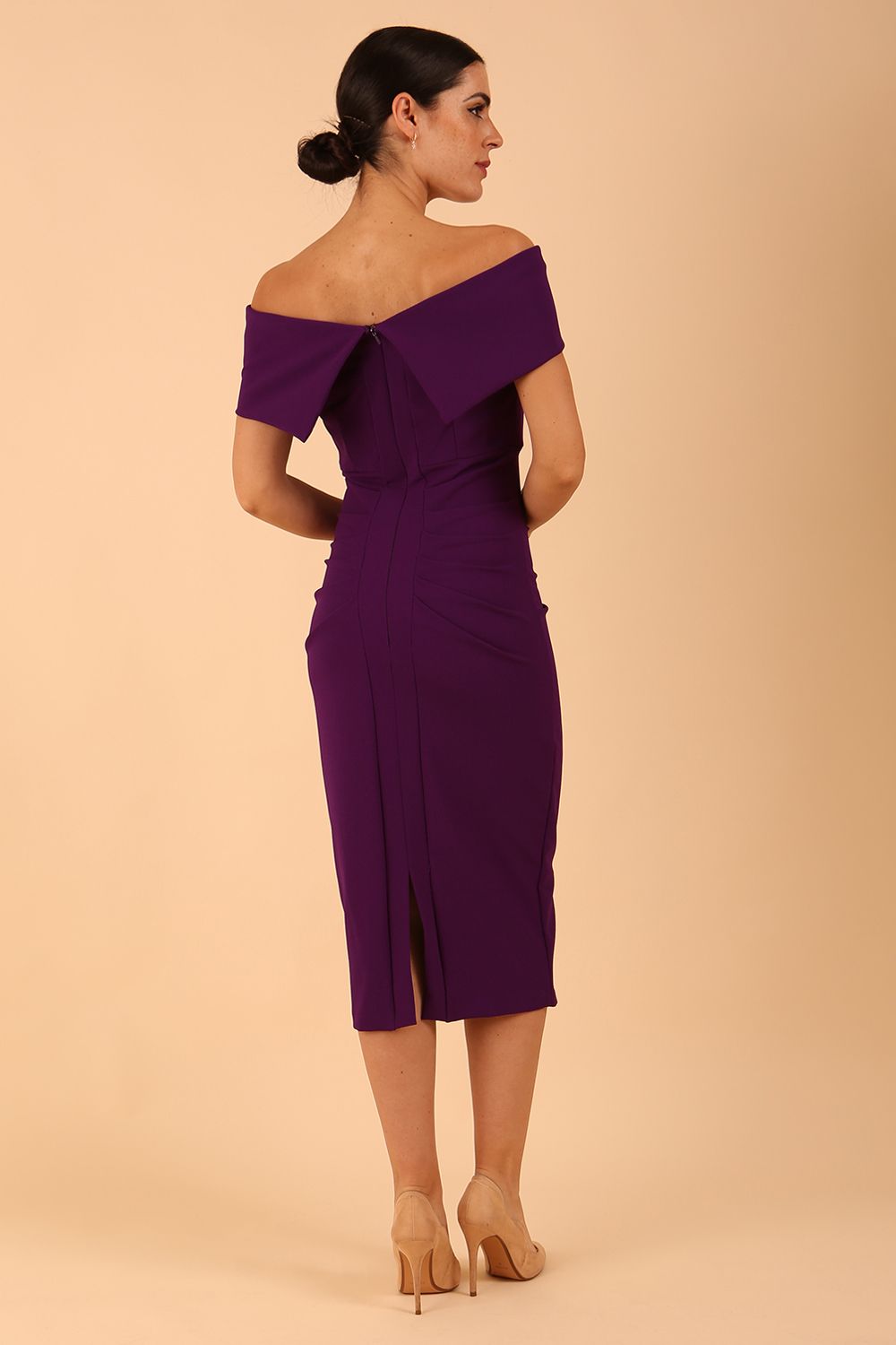 model is wearing diva catwalk amelia pencil dress with bardot neckline and ruched back in Passion Purple back