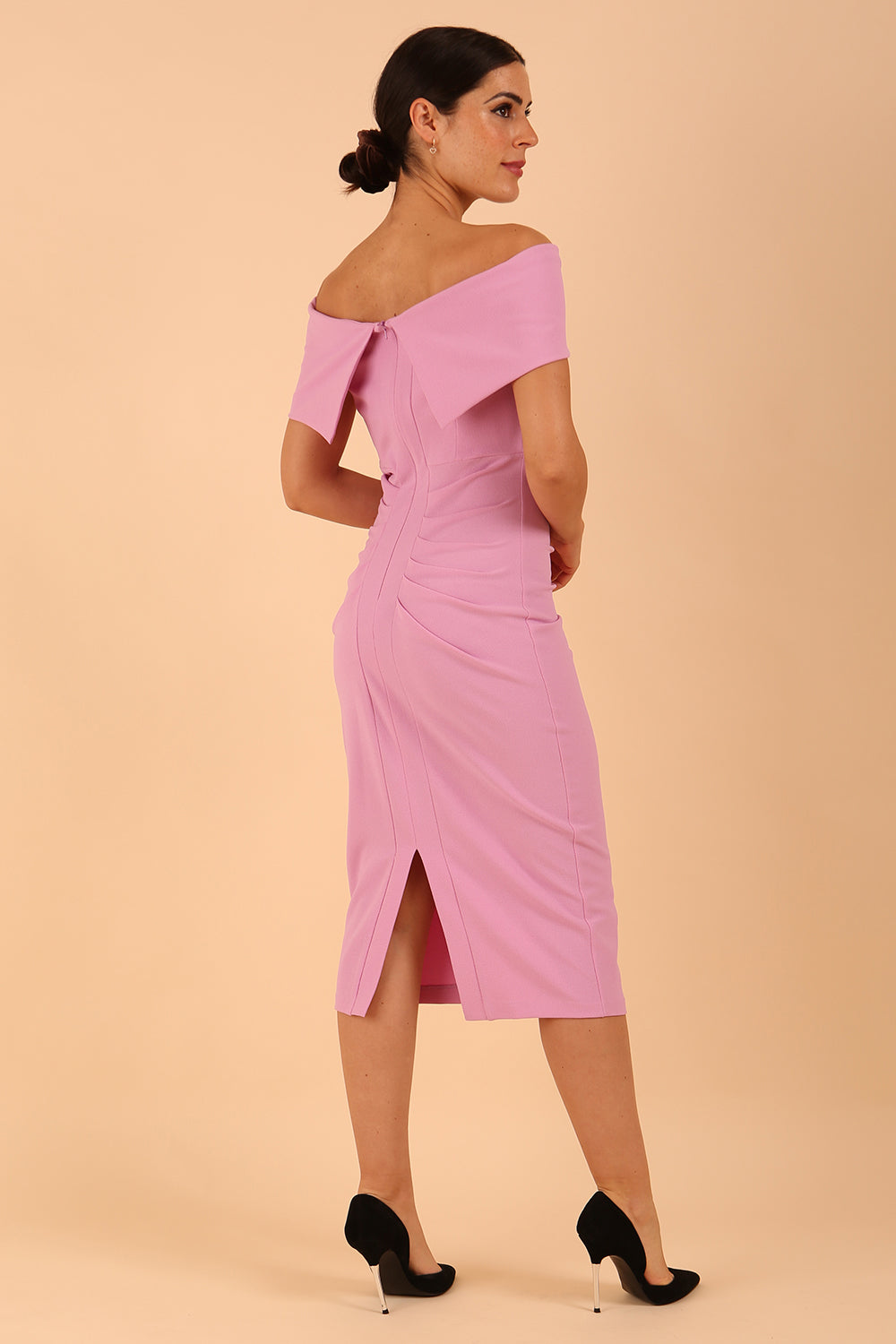 model is wearing diva catwalk amelia pencil dress with bardot neckline and ruched back in Dawn Pink